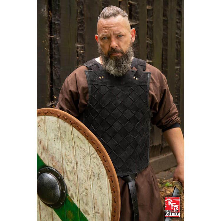 The black RFB leather armor worn by a Viking man from the front with a shield and a sword